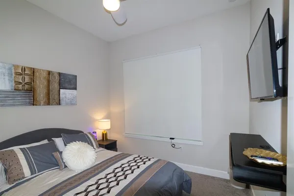 a bedroom with a bed and a chair