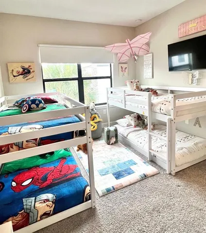 a bedroom with furniture and a flat screen tv