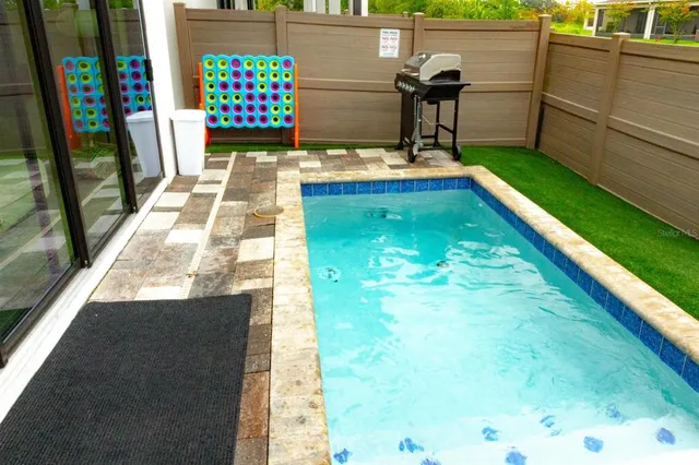 a view of swimming pool with a patio