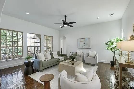 a living room with furniture a chandelier and a large window