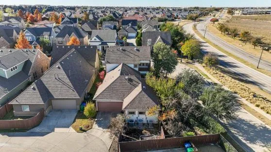 an aerial view of residential houses with outdoor space