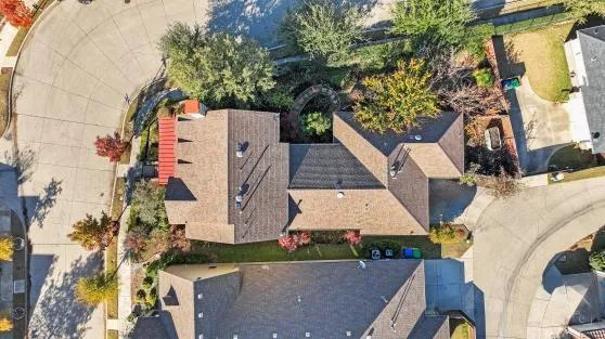 an aerial view of a house with a yard and potted plants
