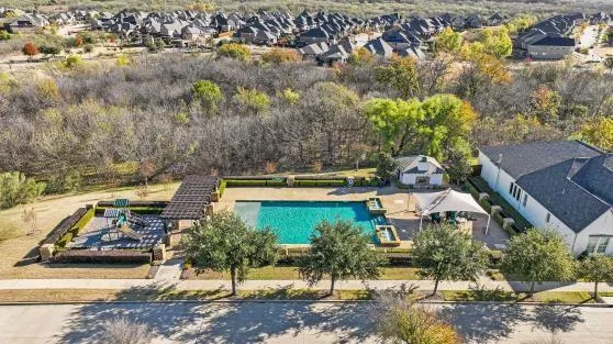 an aerial view of a house with a yard basket ball court and outdoor seating
