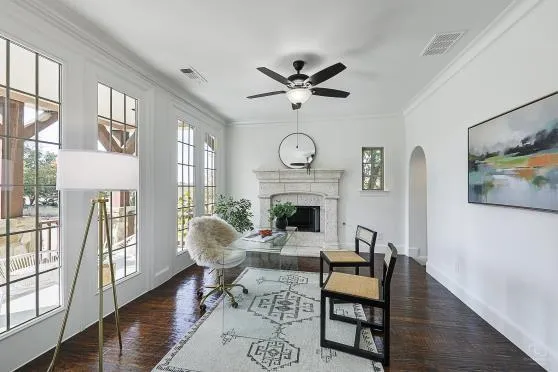 a living room with furniture a fireplace and a large window
