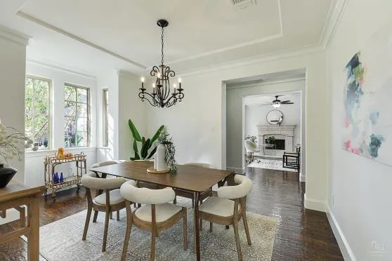 a view of a dining room with furniture wooden floor and a chandelier