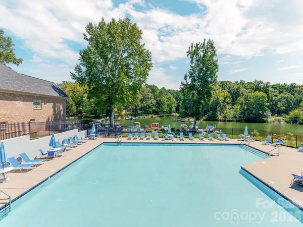 a view of a swimming pool with a patio and a garden