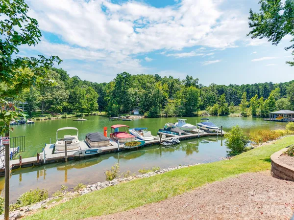an aerial view of a residential houses with outdoor space lake view and boat