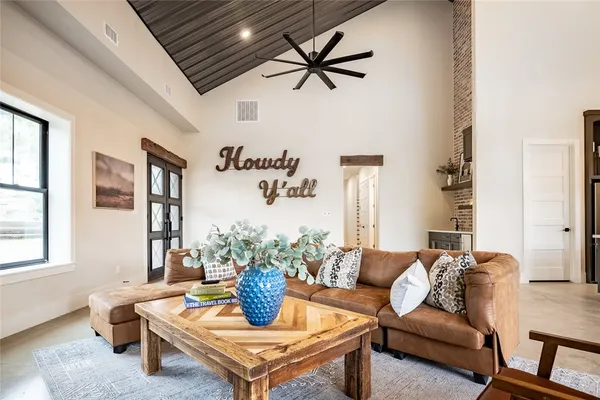 a living room with furniture a window and a potted plant