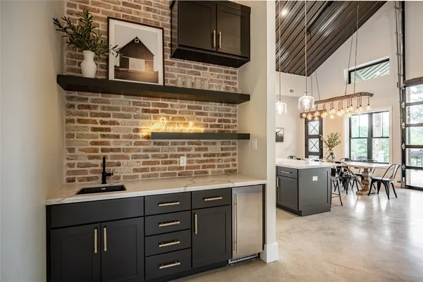 a kitchen with kitchen island granite countertop a stove a sink and a microwave