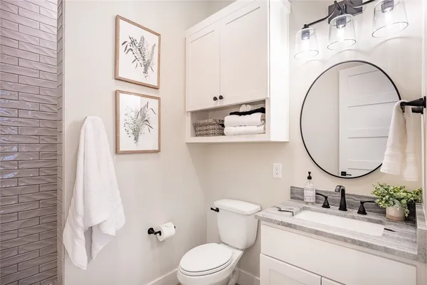 a bathroom with a sink a mirror and shower