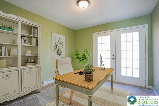an aerial view of a house with yard and large trees