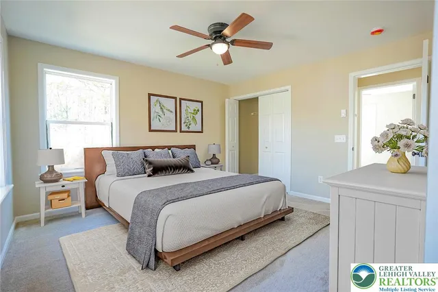 a bedroom with a bed and a window