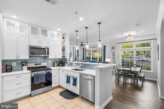 a kitchen with a stove window and cabinets