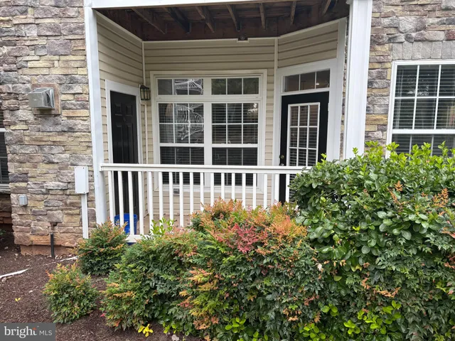 front view of a brick house with a large window