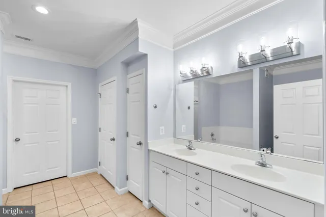a bathroom with a double vanity sink mirror and shower