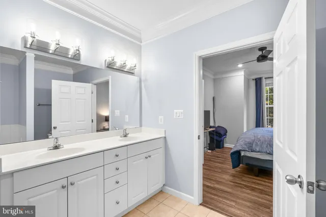 a en suite bathroom with double sink and a mirror