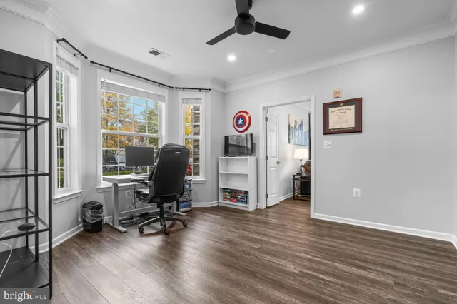 a view of a livingroom with workspace and a window