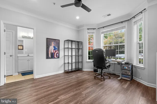 a view of a workspace with furniture and a window