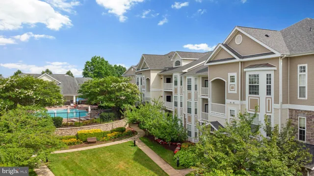 an aerial view of a house with swimming pool and garden