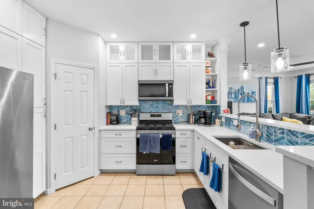 a kitchen with a sink stove and refrigerator