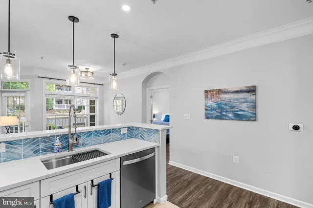 a kitchen with kitchen island a sink stove and wooden floor
