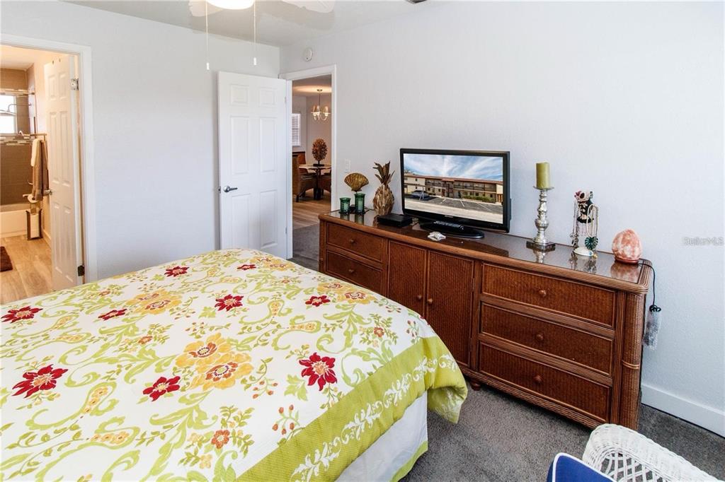 5135 Gemstone Drive, Unit 202 New Port Richey, FL 34652 - Photo 12 of 21 a bedroom with a bed and a flat screen tv