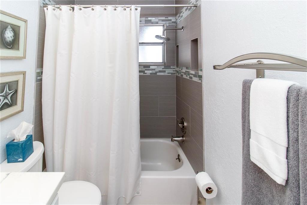 5135 Gemstone Drive, Unit 202 New Port Richey, FL 34652 - Photo 16 of 21 a bathroom with a tub and shower