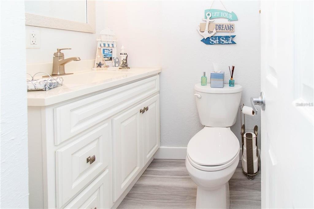 5135 Gemstone Drive, Unit 202 New Port Richey, FL 34652 - Photo 18 of 21 a bathroom with a toilet a sink and a mirror