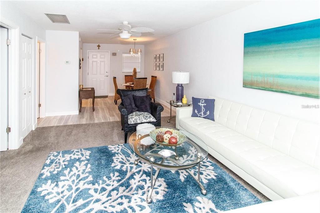 5135 Gemstone Drive, Unit 202 New Port Richey, FL 34652 - Photo 2 of 21 a living room with furniture and a rug