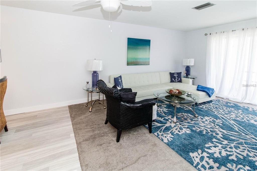 5135 Gemstone Drive, Unit 202 New Port Richey, FL 34652 - Photo 6 of 21 a living room with furniture and a window