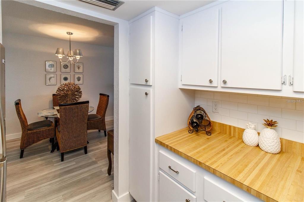 5135 Gemstone Drive, Unit 202 New Port Richey, FL 34652 - Photo 8 of 21 a kitchen with a sink cabinets and wooden floor