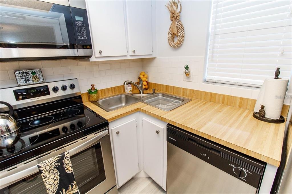 5135 Gemstone Drive, Unit 202 New Port Richey, FL 34652 - Photo 10 of 21 a kitchen with a stove and a sink