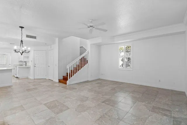 an empty room with windows and fireplace