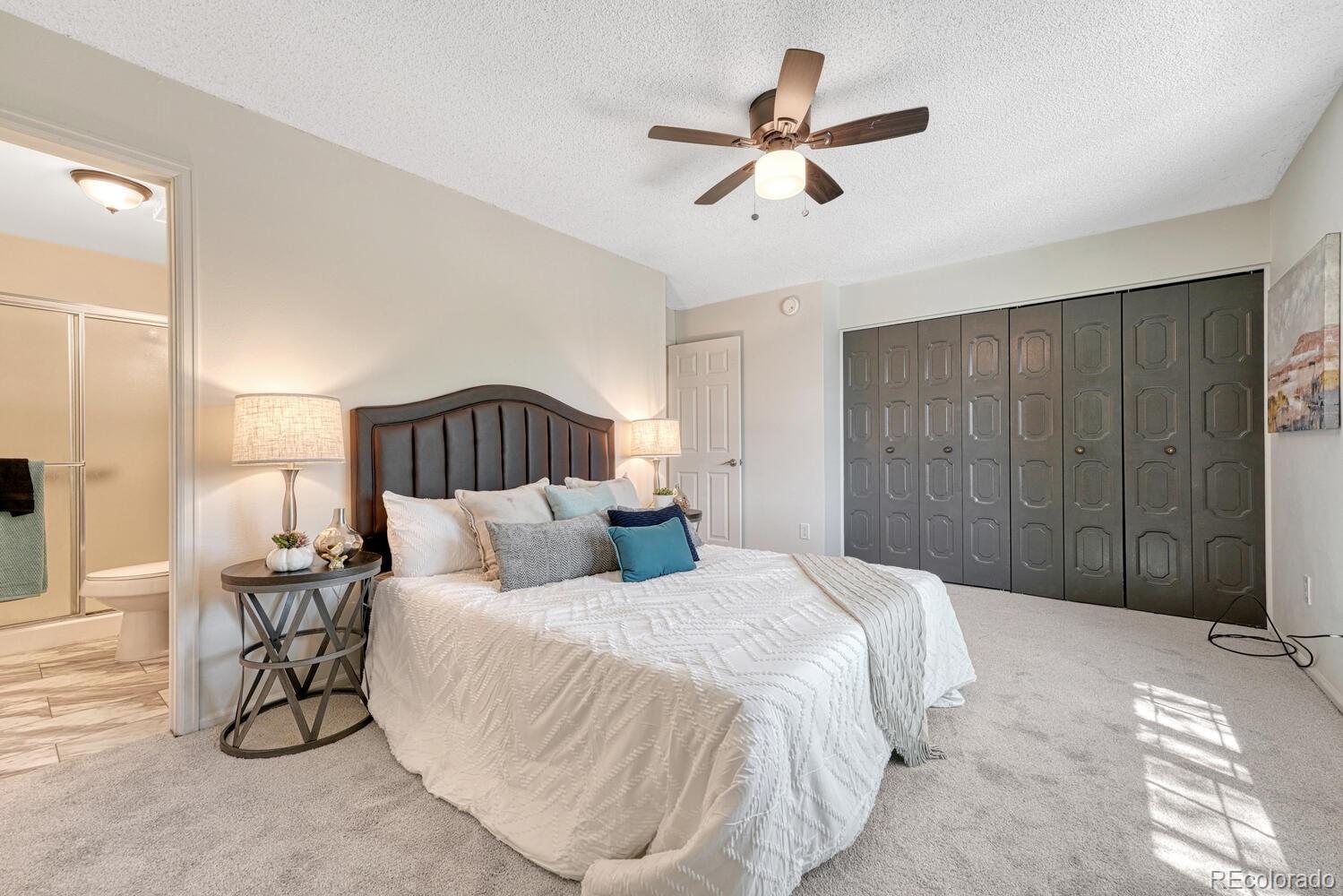 11275 Ash Circle Thornton, CO 80233 - Photo 17 of 38 a bed room with a bed and a ceiling fan