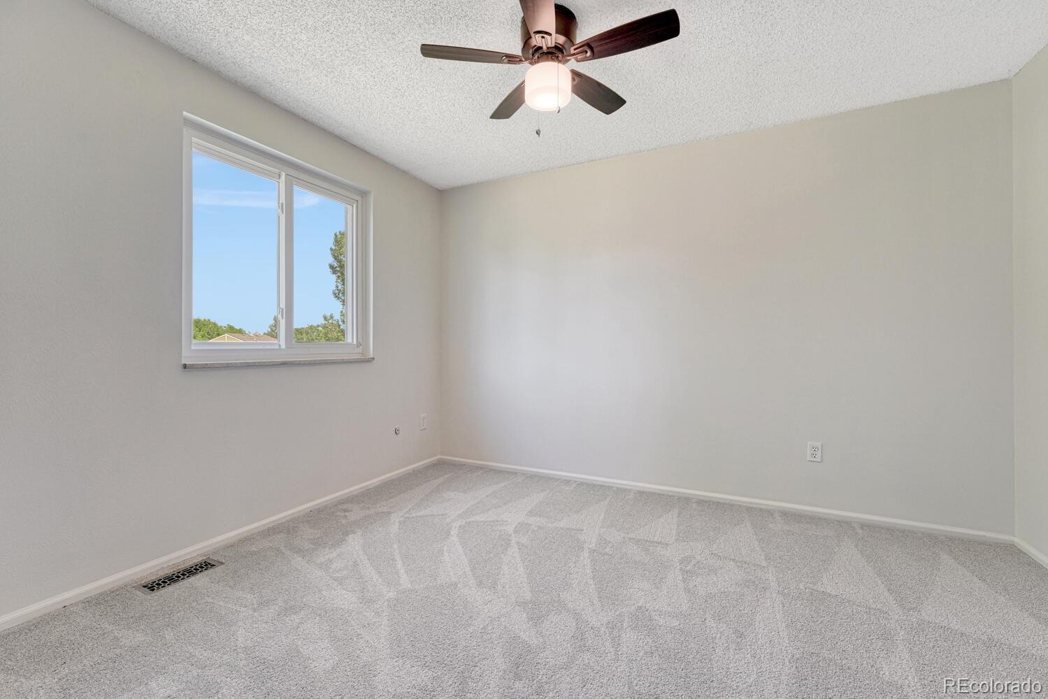 11275 Ash Circle Thornton, CO 80233 - Photo 22 of 38 a view of an empty room with a window