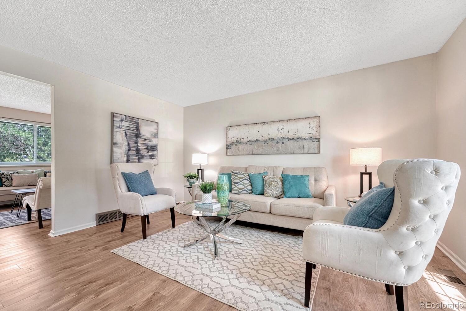 11275 Ash Circle Thornton, CO 80233 - Photo 6 of 38 a living room with furniture and a table