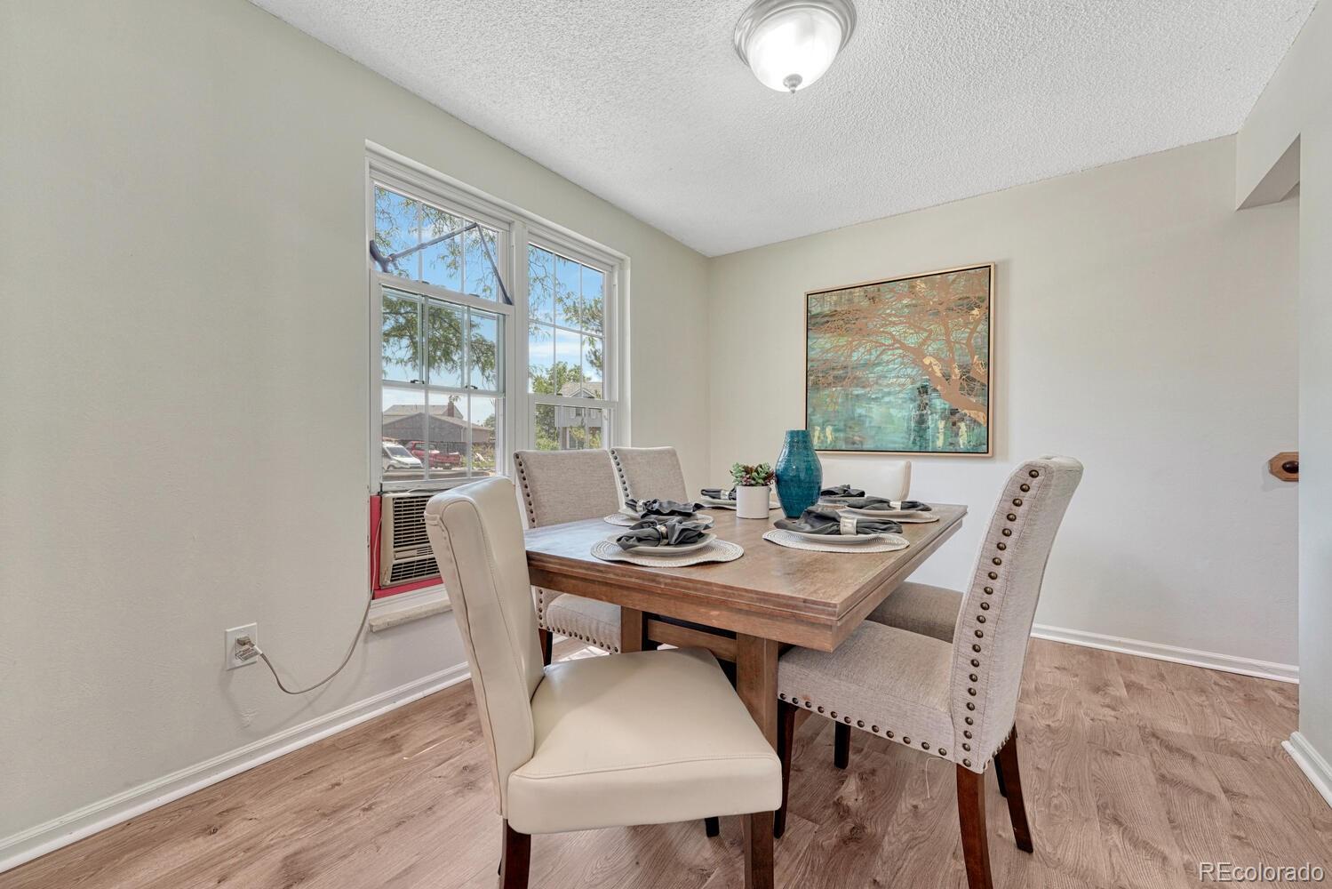 11275 Ash Circle Thornton, CO 80233 - Photo 8 of 38 a view of a dining room with furniture window and wooden floor