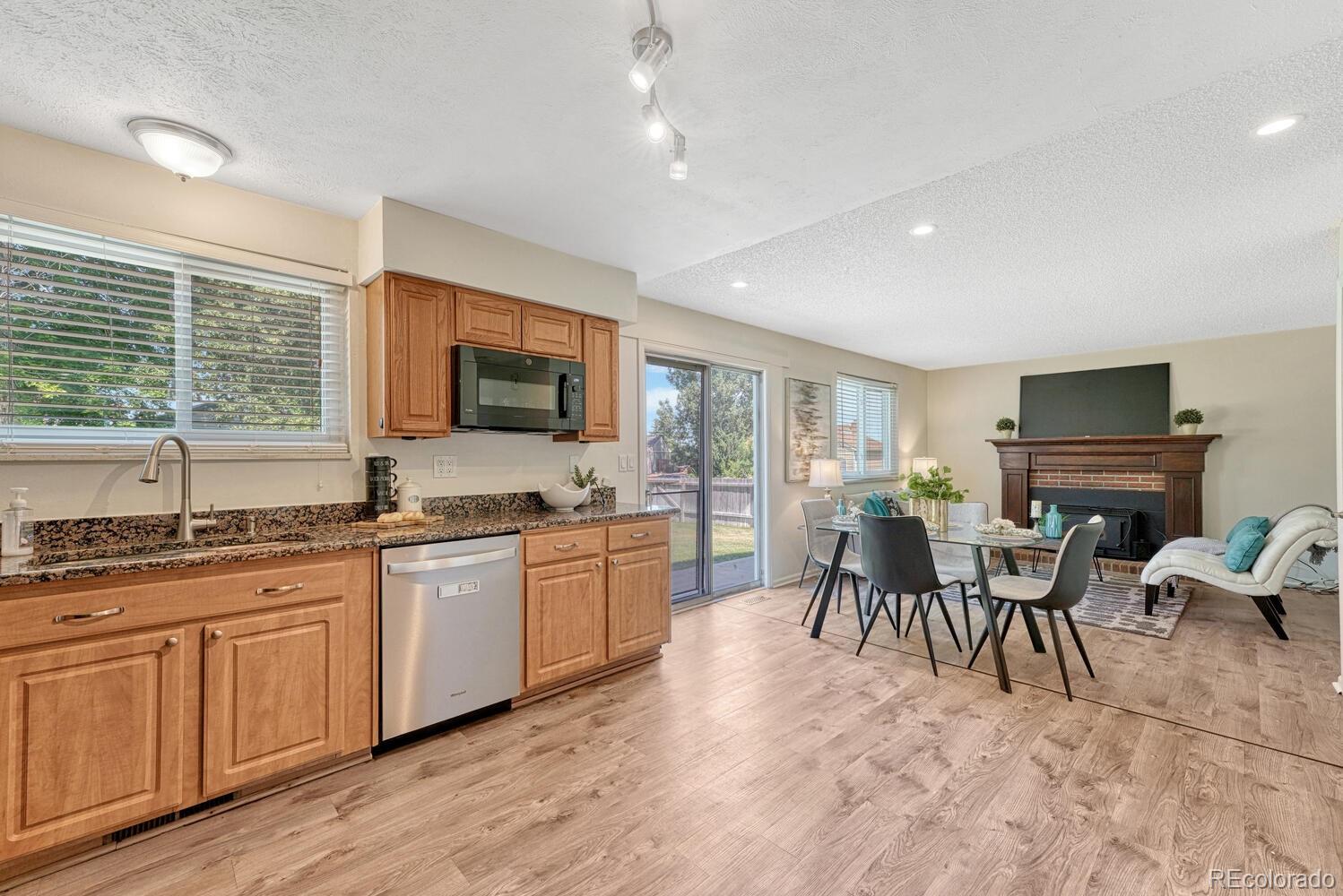 11275 Ash Circle Thornton, CO 80233 - Photo 9 of 38 a kitchen with granite countertop lots of white cabinets a sink and appliances