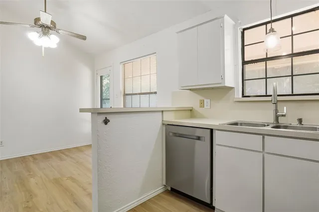 a kitchen with sink cabinets and window