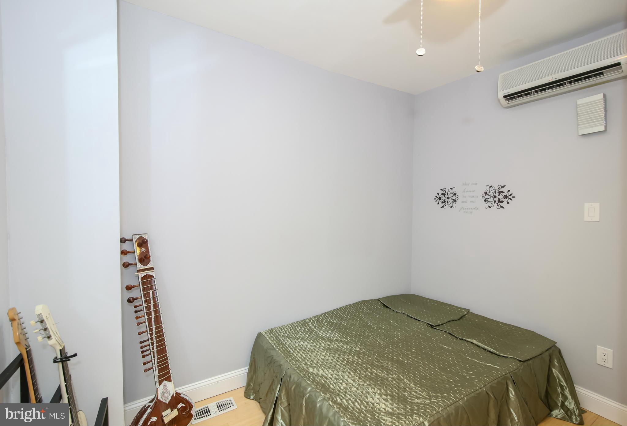 1608 4th Street Northwest Washington, DC 20001 - Photo 12 of 24 a bedroom with a bed and a window