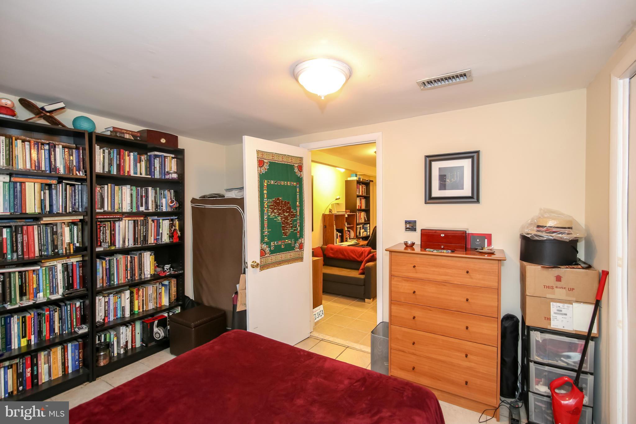 1608 4th Street Northwest Washington, DC 20001 - Photo 17 of 24 a bedroom with furniture and a book shelf