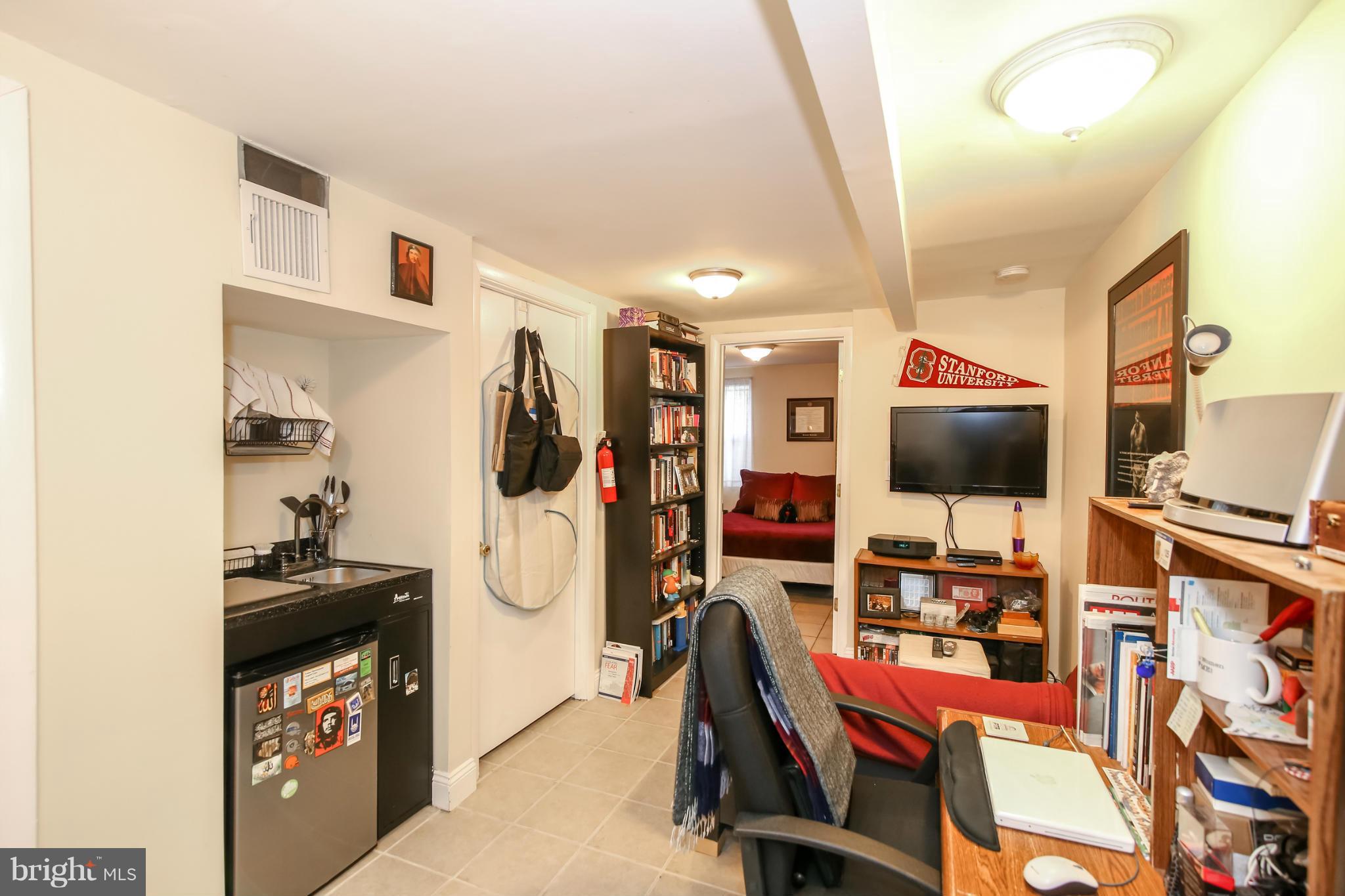1608 4th Street Northwest Washington, DC 20001 - Photo 19 of 24 a room with furniture a flat screen tv and gym equipment