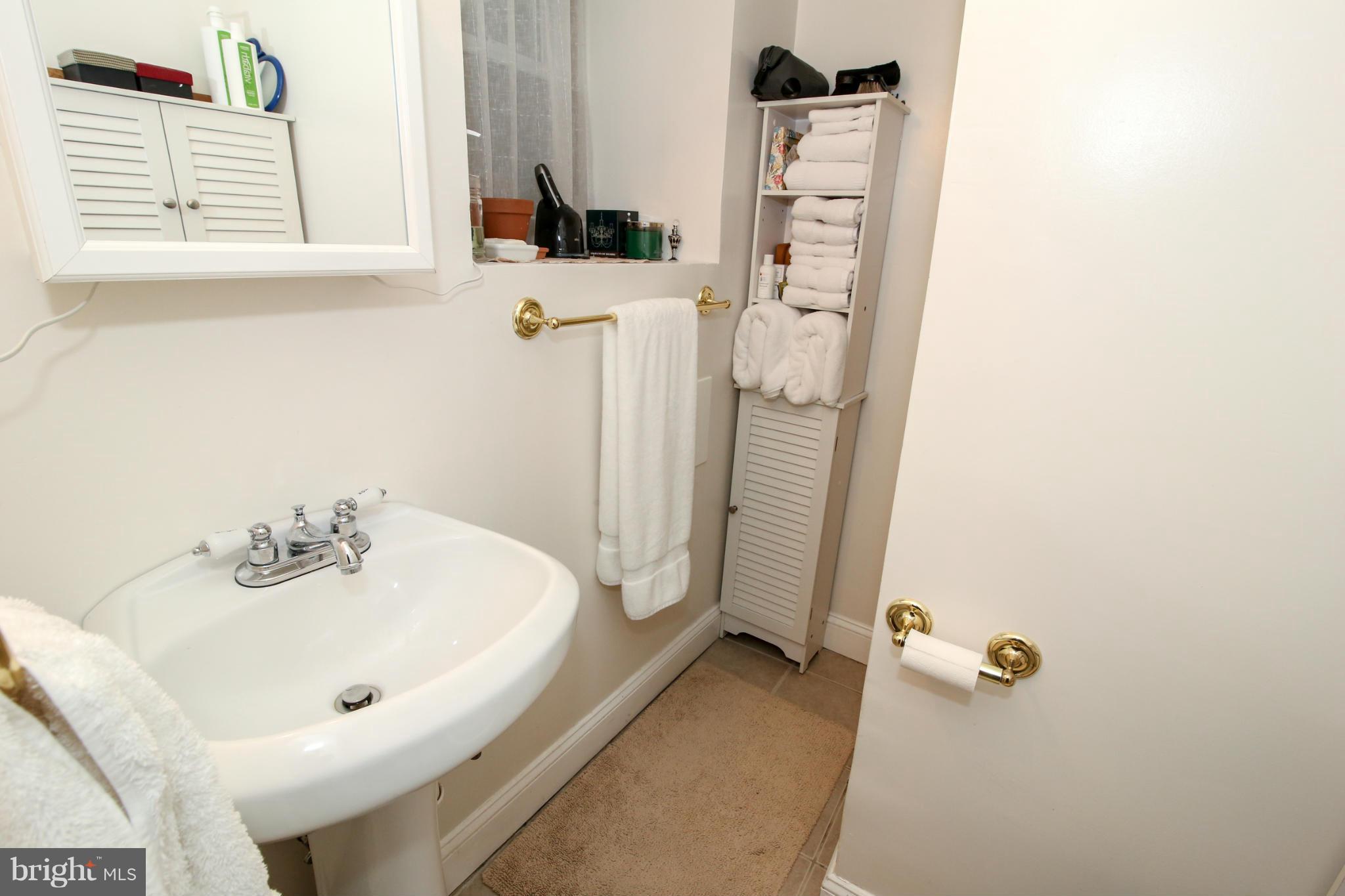 1608 4th Street Northwest Washington, DC 20001 - Photo 20 of 24 a bathroom with a sink a mirror and shower