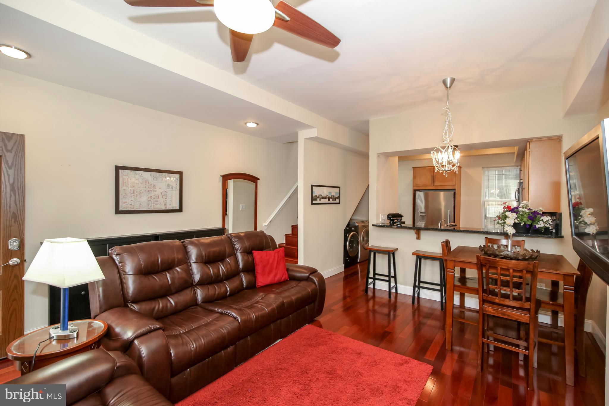 1608 4th Street Northwest Washington, DC 20001 - Photo 3 of 24 a living room with furniture and a chandelier