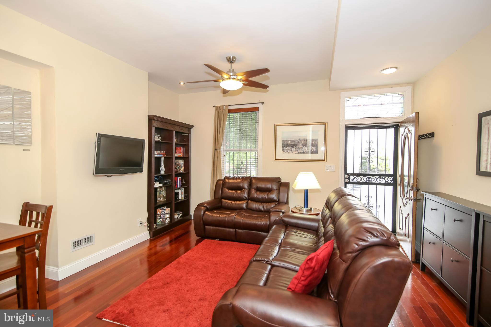 1608 4th Street Northwest Washington, DC 20001 - Photo 4 of 24 a living room with furniture and a flat screen tv