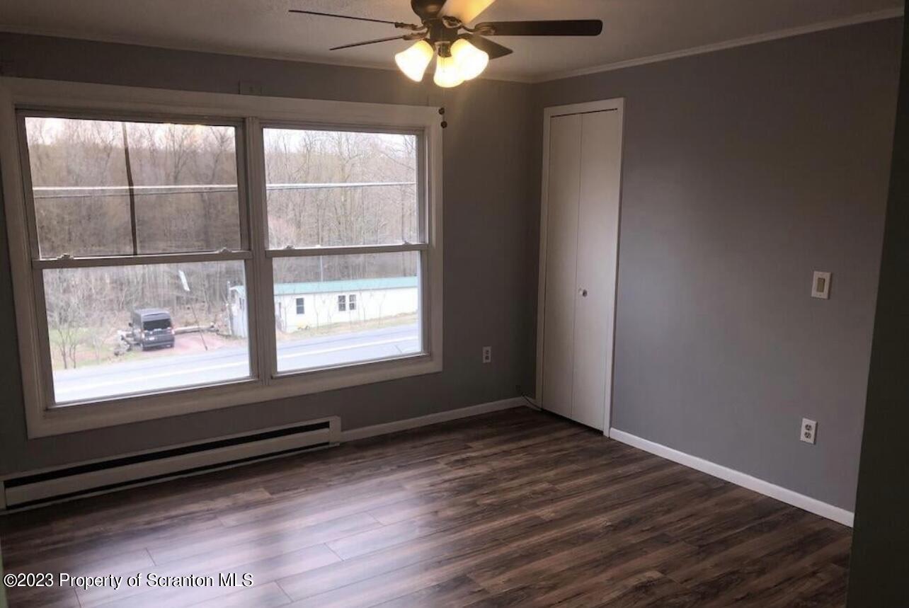 4441 Jubilee Road Moscow, PA 18444 - Photo 12 of 15 a view of an empty room with wooden floor and a window