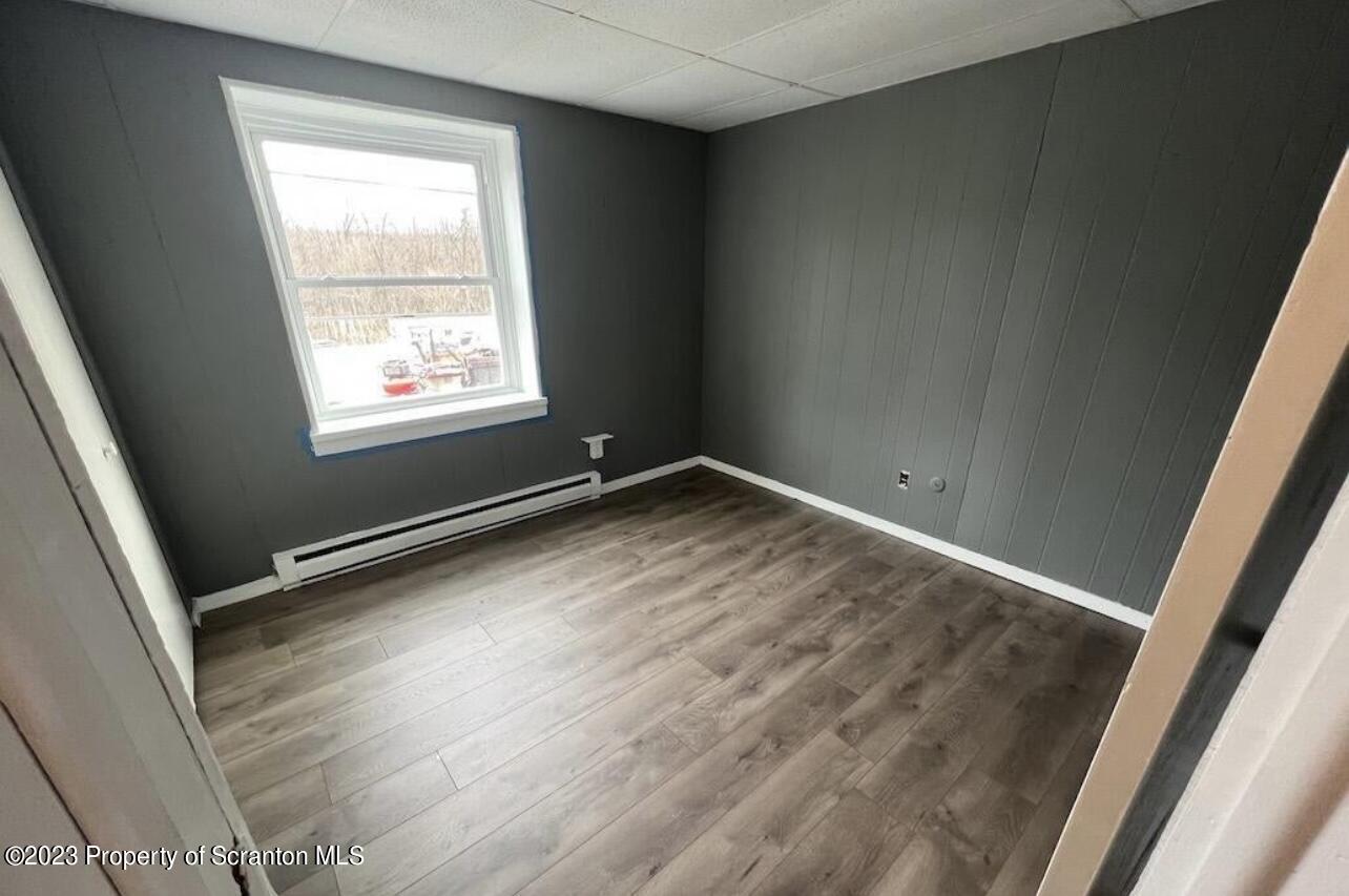 4441 Jubilee Road Moscow, PA 18444 - Photo 14 of 15 an empty room with wooden floor and windows