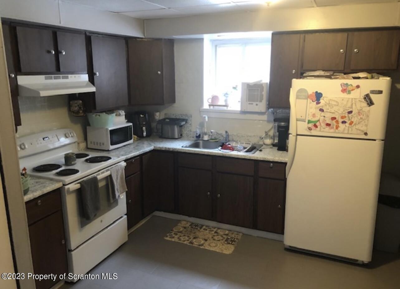 4441 Jubilee Road Moscow, PA 18444 - Photo 6 of 15 a kitchen with a white stove and white cabinets