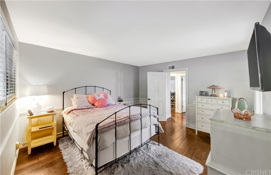 7078 Deveron Ridge Road West Hills, CA 91307 - Photo 21 of 62 a bedroom with a bed and a flat tv screen on dresser