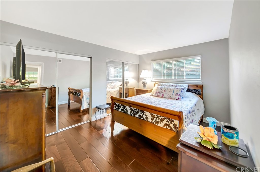 7078 Deveron Ridge Road West Hills, CA 91307 - Photo 28 of 62 a bedroom with a bed and wooden floor